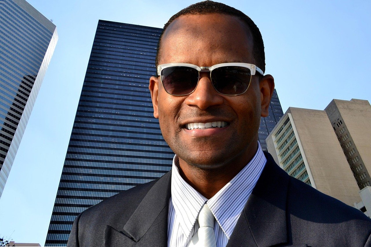 business, people, portrait, man, adult, success, sunglasses, eyewear, outdoors, corporate, office, work, employee, ceo, company, african american, male, professional, person, young, street, suit, looking, city, one, manager, worker, smiling, businessman, communication, smart, woman, businesswoman, elegance, occupation, finance, happy, handsome, formal, indian, jamaican, haitian, tie, pin stripped, suit jacket, blue, jacket, buildings, commercial, sky, skies, tall, executive, attractive, lifestyle, confident, happiness, white, positive, modern, black, boss, successful, smile, model, black man, black people, african man, dominican man, barbadian, trinidadian, fashion, shades, sun glasses, high class, warm, intelligent, business man, owner, confidence, button down, pin stripe, men's clothing, business attire, masculine, broad shoulders, dark, brown, white background, isolated, modeling, fashion model, technology, blue finance, blue smile, blue clothes, blue businessman, blue management, ceo, ceo, ceo, ceo, ceo